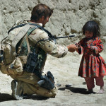 A Special Forces soldier gives a young Afghan girl some food after he took part in a search of her village Friday in Zabul Province. The SF and AFghan National Army soldiers were looking for Taliban fighters there, but their search turned up none.